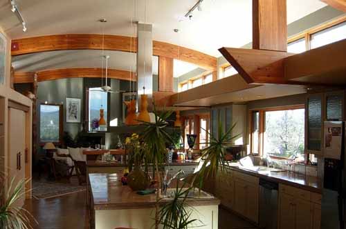 A well-lit great room with  “light shelf” just below upper clerestory windows that is a signature architectural feature of designs by Michael Frerking